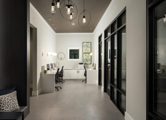Sleek Business Lounge with Computers, Printer, and Lounge Seating