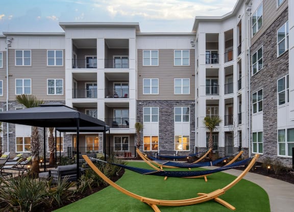 Outdoor Courtyard with Cabanas, Hammocks, and Lush Landscaping