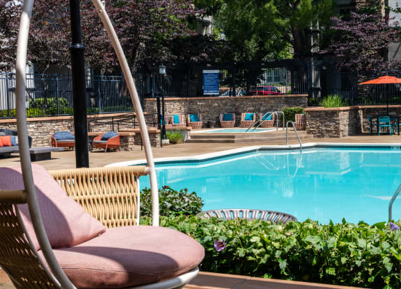 Relaxing Community Pool Featuring Cushioned Seating and Water Views