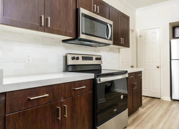 Quartz Countertops Highlight This Updated Kitchen with Stainless Steel Appliances
