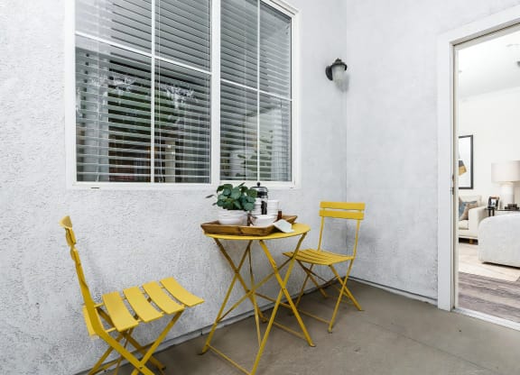 Apartment Patio Space with Modern Outdoor Furniture and Potted Plant