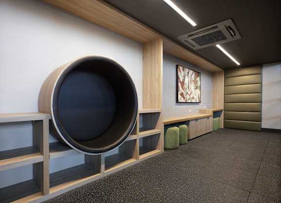 Kids Lounge with circular built-in seating, low storage, padded walls, and a wall-mounted television.