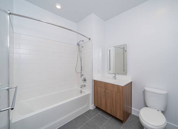 Modern bathroom with white subway tile tub at Port & Main Apartments, Port Chester, NY