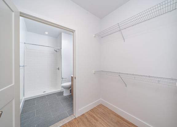 Walk-in closet with wire shelving and bathroom at Port & Main Apartments, Port Chester, 10573