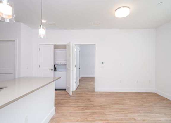 Open concept living area with wood style flooring at Port & Main Apartments, New York