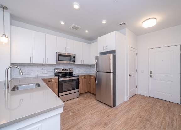 Modern kitchen with stainless steel appliances at Port & Main Apartments, Port Chester, NY 10573