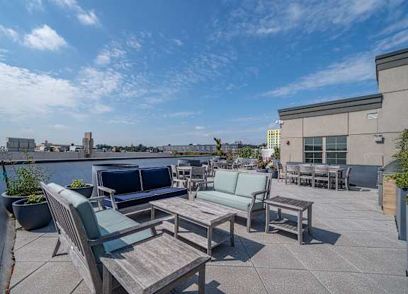 Rooftop terrace with seating and city views at Port & Main Apartments, Port Chester, 10573