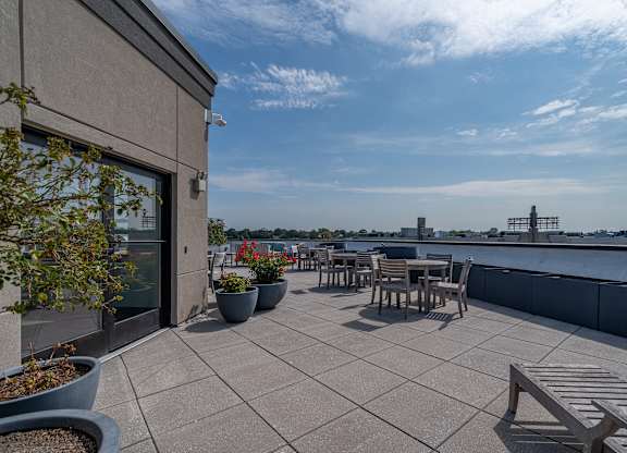 Rooftop terrace with seating and skyline views at Port & Main Apartments, Port Chester