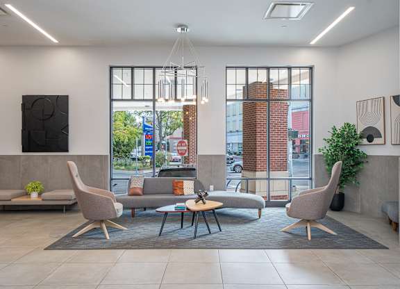 Contemporary lobby lounge with modern furnishings at Port & Main Apartments, New York