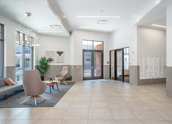 Contemporary lobby with seating and mailroom at Port & Main Apartments, Port Chester, NY 10573