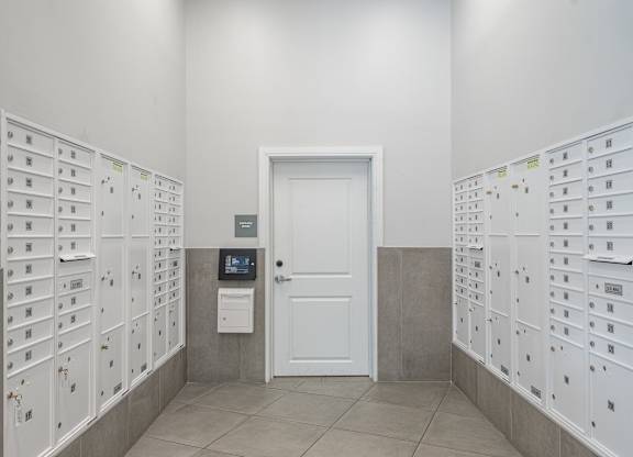 Mail room with package lockers and door access at Port & Main Apartments, Port Chester, NY