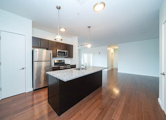 Open concept kitchen with island and pendant lights at 750 Summer Street Apartments, Stamford, 06901