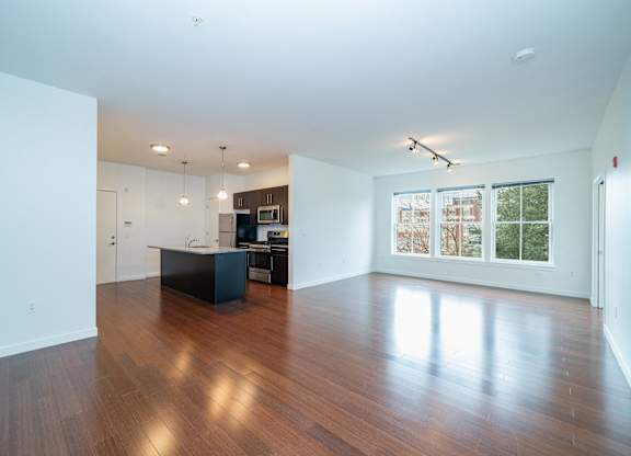Open concept living area with hardwood floors at 750 Summer Street Apartments, Stamford, Connecticut