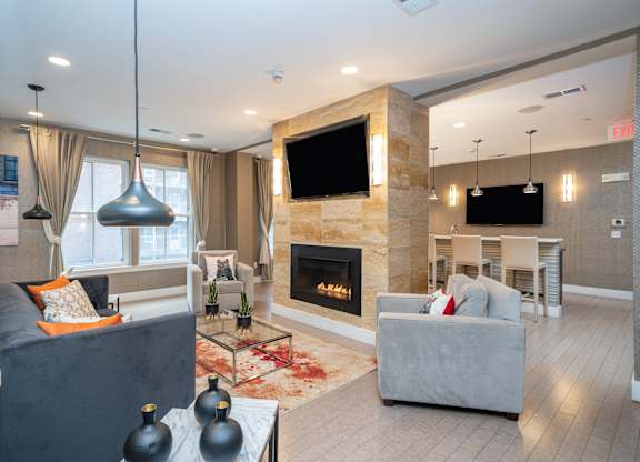 Clubhouse lounge with fireplace and dining area at 750 Summer Street Apartments, Connecticut