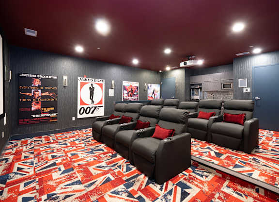 Home theater with reclining seats and themed carpet at 750 Summer Street Apartments, Stamford, CT