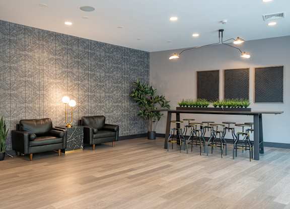 Coworking lounge with seating and communal table at 750 Summer Street Apartments, Stamford, 06901
