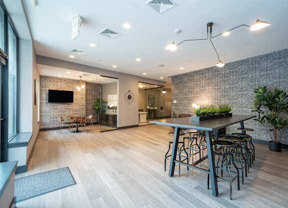 Contemporary clubhouse lounge with high top seating at 750 Summer Street Apartments, Stamford, Connecticut