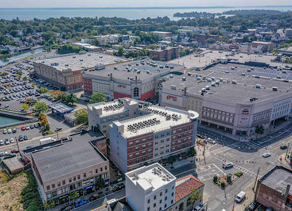 Aerial view of community and surrounding shopping center at Port & Main Apartments, Port Chester, NY 10573