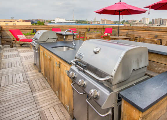 Rooftop grilling station with sink and countertop at 750 Summer Street Apartments, Connecticut
