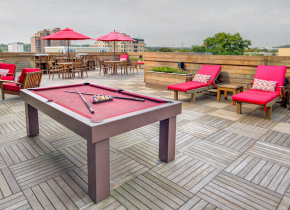 Rooftop deck with billiard table and lounge seating at 750 Summer Street Apartments, Stamford, CT 06901