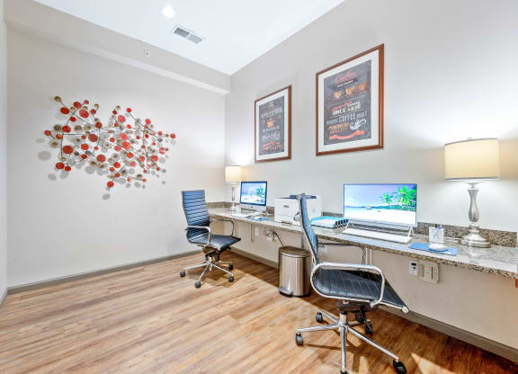 a room with two computers and two chairs