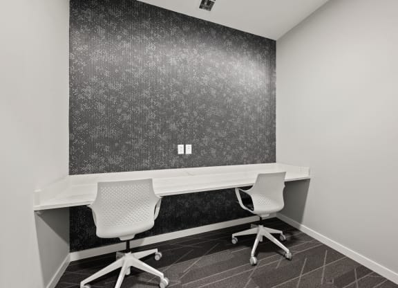 an office with two desks and two chairs