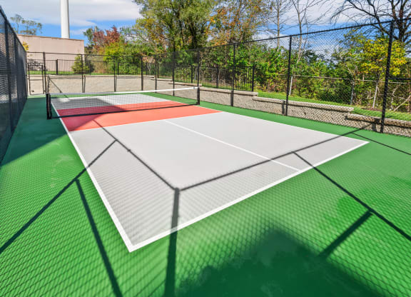 the tennis court is equipped with nets and is wheelchair accessible