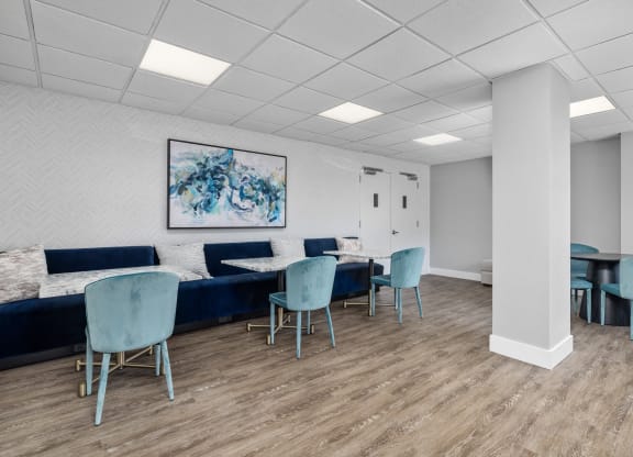 a waiting room with blue chairs and couches