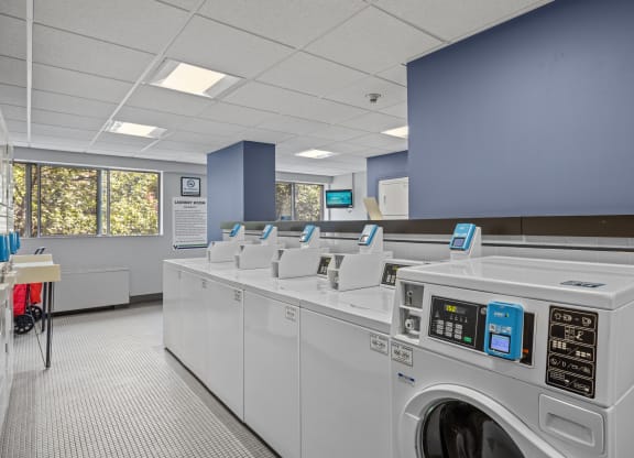 a laundry room with washers and dryers