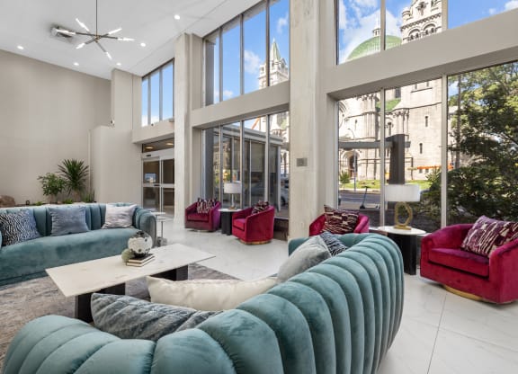 a living room filled with furniture and large windows