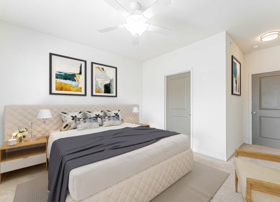 a bedroom with a large bed and a ceiling fan