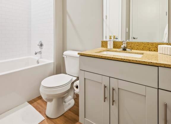 a bathroom with a toilet and a shower and a sink