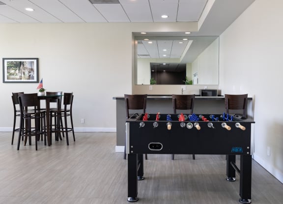 a game room with a pool table and a bar