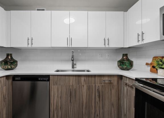 a kitchen with white countertops and wooden cabinets