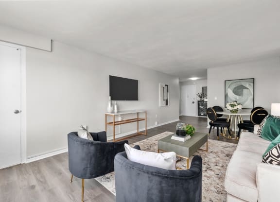 a living room with white walls and hardwood flooring