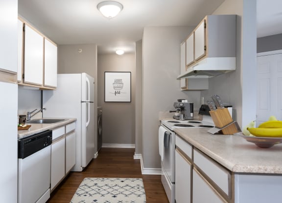 a kitchen with white appliances and counters and a white refrigerator