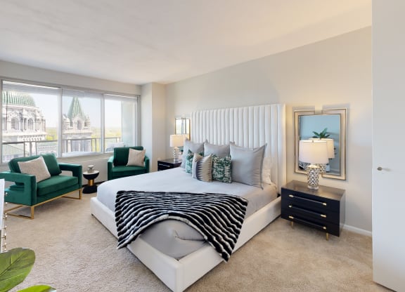 a bedroom with a bed and a chair in front of a window