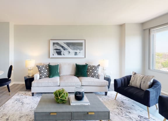 a living room with a couch coffee table and dining table