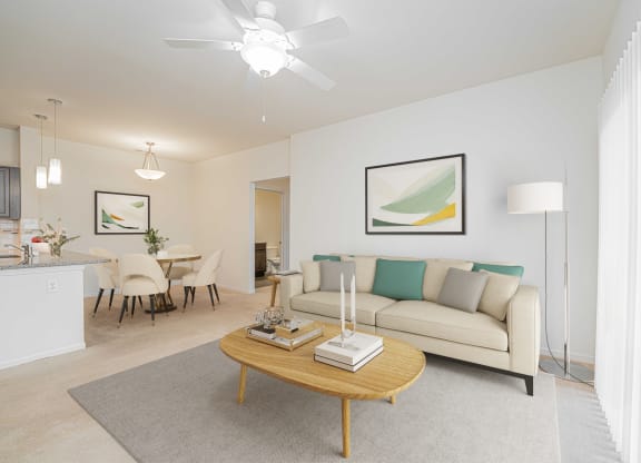 a living room with white walls and a ceiling fan