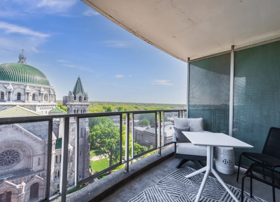 an apartment with a balcony and a view of the basilica of the sacre coeur