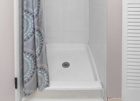 a bathroom with a shower and a curtain