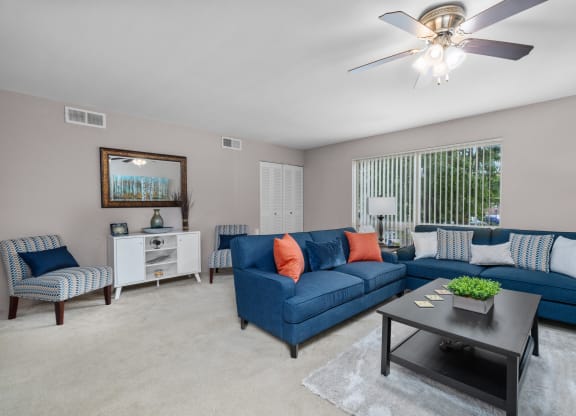 a living room with blue couches and a coffee table