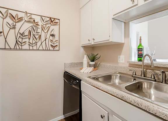 a kitchen with a sink and a window