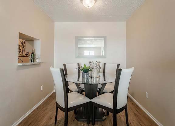 a dining room with a table and chairs