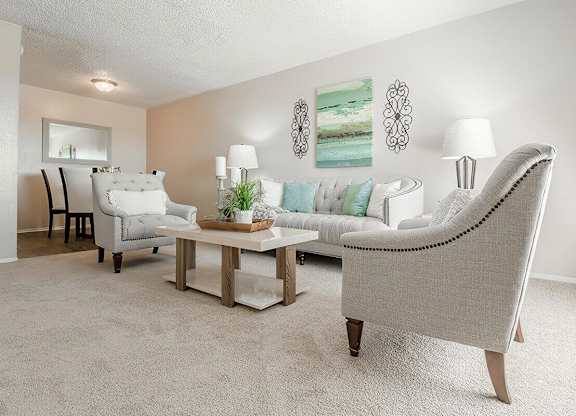 a living room with couches and chairs and a table