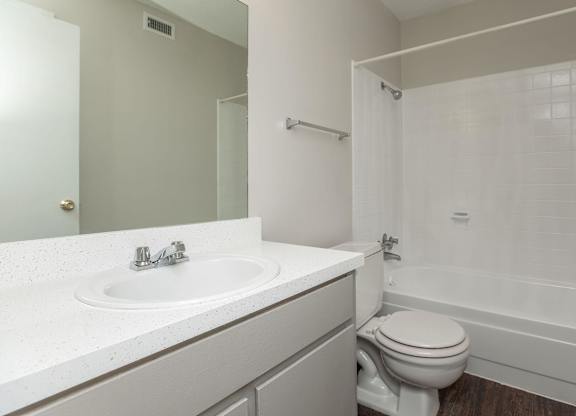 an empty bathroom with a sink toilet and shower
