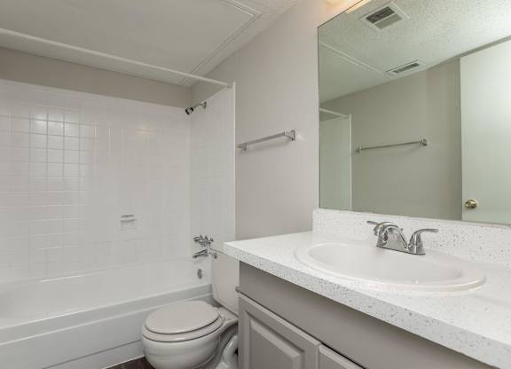 a bathroom with a sink toilet and a bath tub