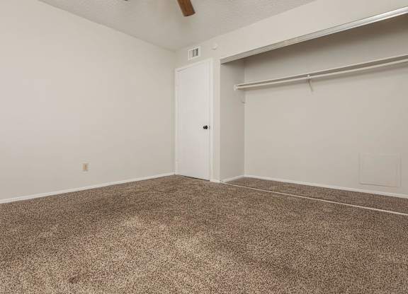 an empty room with carpet and a garage door