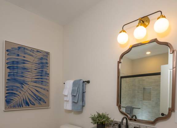 A bathroom with a green cabinet and a white toilet.