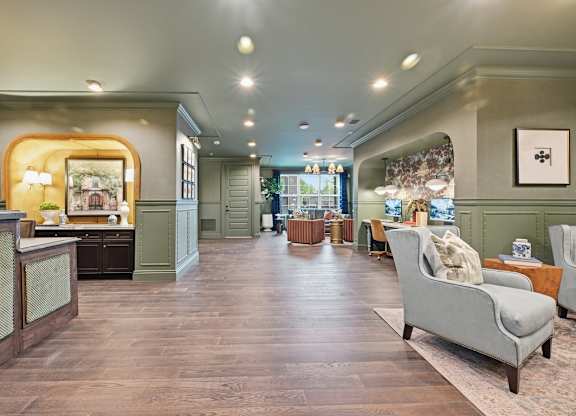 A living room with a grey sofa and wooden floors.
